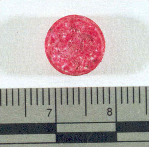 image of a rose-colored tablet, imprinted with the Chanel logo, suspected MDMA