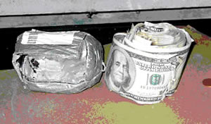photo-ice methamphetamine and a roll of partially burned U.S. currency