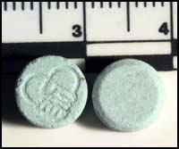 photo-blue tablets with a "handshake" logo on one side, suspected ecstasy