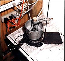 a red-colored liquid cooking in a 250 milliliter Erlenmeyer flask on a hotplate in the living room